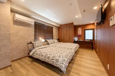a bedroom with a large bed in a room at Peace Inn Shinjuku Tokyo in Tokyo