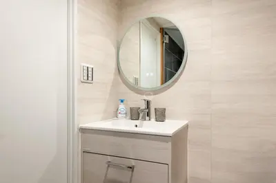 a bathroom with a sink and a mirror at Peace Inn Shinjuku Tokyo in Tokyo