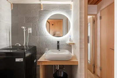 a bathroom with a sink and a mirror at Peace Inn Shinjuku Tokyo in Tokyo