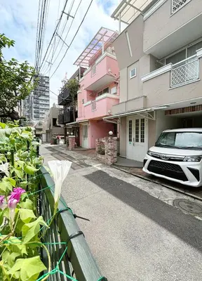 a car parked on a street next to a building at WE Hotel Family House in Tokyo