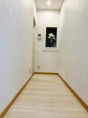 an empty hallway with white walls and a painting on the wall at Ueno Yuyuhouse 1Room for rent, Close to Senso-ji Temple,Kaminarimon Gate,Kappabashi Dougu Street,Akihabara,Shinjuku and Disneyland in Tokyo