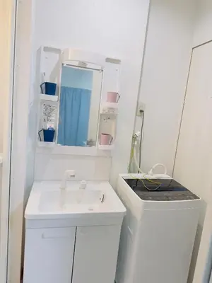 a white bathroom with a sink and a mirror at Ueno Yuyuhouse 1Room for rent, Close to Senso-ji Temple,Kaminarimon Gate,Kappabashi Dougu Street,Akihabara,Shinjuku and Disneyland in Tokyo