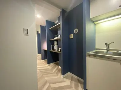 a bathroom with a sink and a mirror and blue walls at Shibuya WAVE 301 in Tokyo