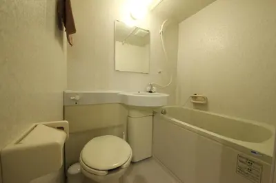 a white bathroom with a toilet and a sink at Shibuya WAVE 301 in Tokyo