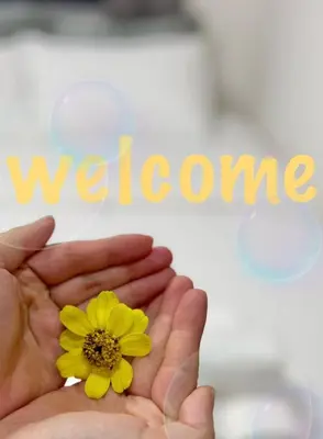 a hand holding a yellow flower with the word welcome at GLOU Shinjuku Family - Urban Stay in Tokyo Shinjuku Area, Walking distance of Kabukicho in Tokyo