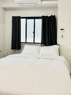a white bed in a room with a window at GLOU Shinjuku Family - Urban Stay in Tokyo Shinjuku Area, Walking distance of Kabukicho in Tokyo