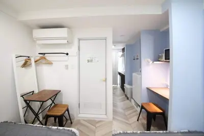 a small kitchen with a table and chairs in a room at Shibuya WAVE 302 in Tokyo