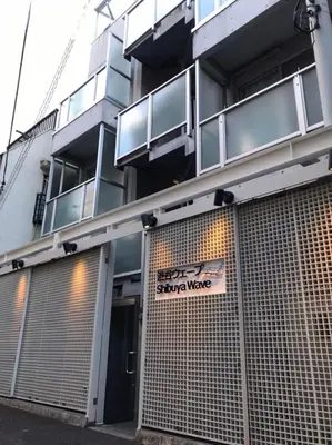 a building with a sign on the front of it at Shibuya WAVE 302 in Tokyo