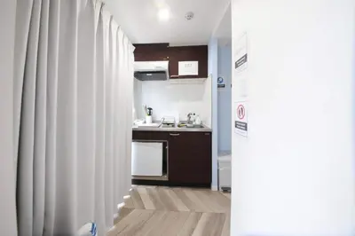 a small kitchen with a sink and a refrigerator at Shibuya WAVE 302 in Tokyo