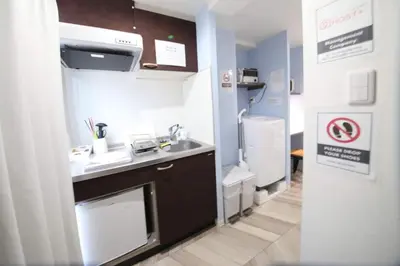 a small kitchen with a sink and a refrigerator at Shibuya WAVE 302 in Tokyo
