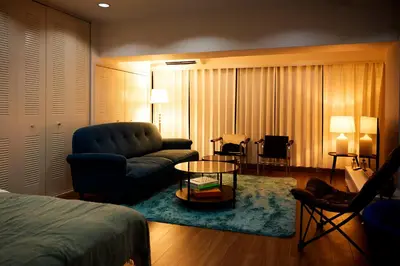 a living room with a couch and a table at Central Shinjuku apartment with beautiful city view 3stops to Shibuya in Tokyo