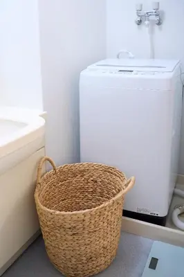 a bathroom with a basket next to a sink at Central Shinjuku apartment with beautiful city view 3stops to Shibuya in Tokyo