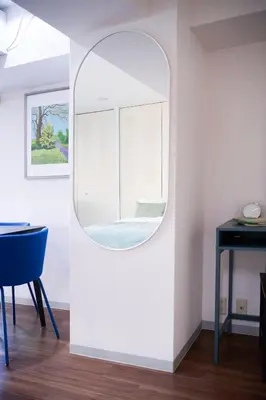 a mirror in a room with a table and a chair at Central Shinjuku apartment with beautiful city view 3stops to Shibuya in Tokyo