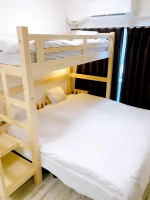 a bedroom with two bunk beds and a bed at SKY BLUE HOUSE Asakusabashi in Tokyo