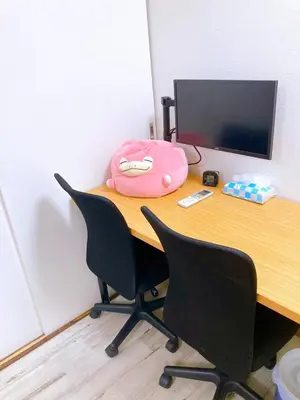 a desk with two chairs and a pink bag on it at SKY BLUE HOUSE Asakusabashi in Tokyo