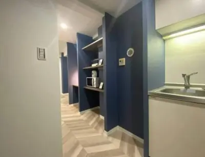 a bathroom with a sink and a blue wall at Shibuya WAVE 402 in Tokyo