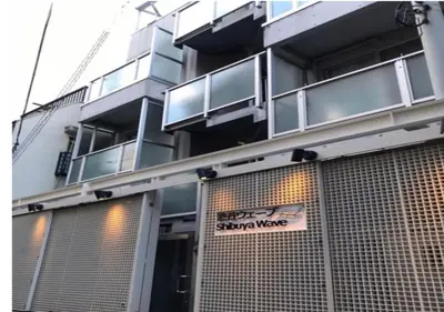 a building with a sign on the front of it at Shibuya WAVE 402 in Tokyo