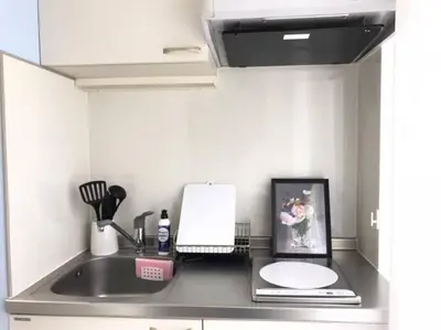 a kitchen counter with a sink and a microwave at Shibuya WAVE 402 in Tokyo