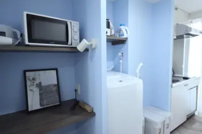 a microwave sitting on a shelf in a kitchen at Shibuya WAVE 402 in Tokyo