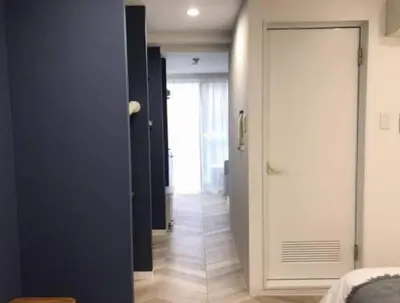 a hallway with a door leading to a room at Shibuya WAVE 402 in Tokyo