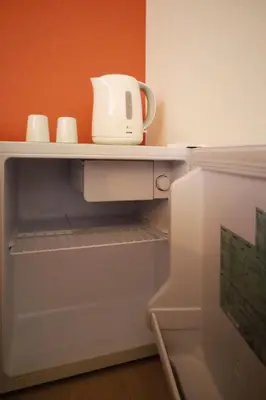 a white appliance sitting on a shelf in a refrigerator at \u5c3e\u4e45\u65b0\u7bc9 in Tokyo