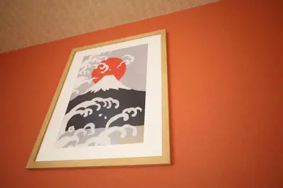 a framed picture of a tsunami on a wall at \u5c3e\u4e45\u65b0\u7bc9 in Tokyo