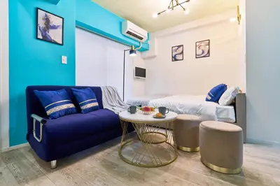 a living room with a couch and a table at Shinjuku Waseda Stay in Tokyo