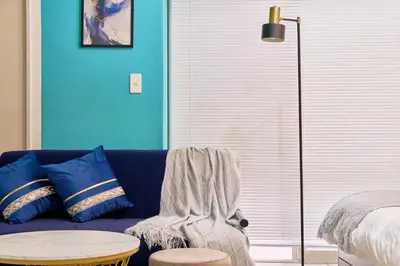 a blue living room with a blue couch and a table at Shinjuku Waseda Stay in Tokyo