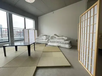 a room with a couch and a table and a window at ShibuyaYoyogi Shinjuku 8psn 70sqm New Apartment Maisonette in Tokyo