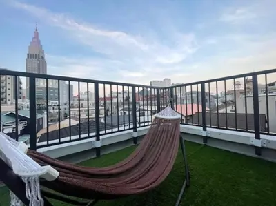 a hammock on a balcony with a view of a city at ShibuyaYoyogi Shinjuku 8psn 70sqm New Apartment Maisonette in Tokyo