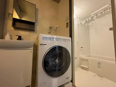 a washing machine in a bathroom next to a sink at ShibuyaYoyogi Shinjuku 8psn 70sqm New Apartment Maisonette in Tokyo