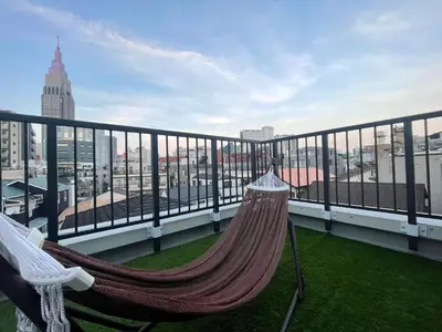 a hammock on a balcony with a view of a city at ShibuyaYoyogi Shinjuku 8psn 70sqm New Apartment Maisonette in Tokyo