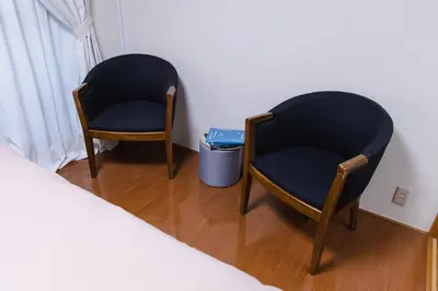 two chairs sitting next to a bed in a room at King bed house 5mins from Ikebukuro by train in Tokyo
