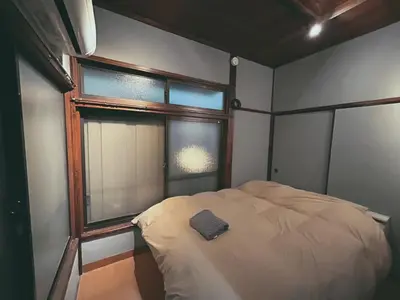 a small bedroom with a bed and a window at 5min to Station, Best Value 3BR Sleeps 8, Quiet Area in Tokyo