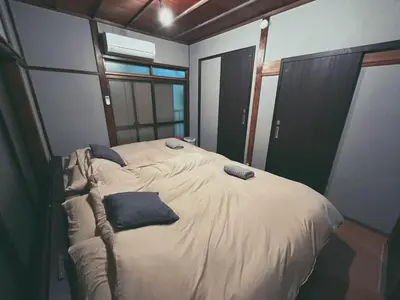a bedroom with a bed with pillows on it at 5min to Station, Best Value 3BR Sleeps 8, Quiet Area in Tokyo