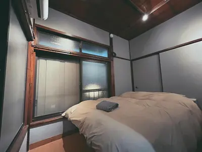 a bedroom with a bed and a window at 5min to Station, Best Value 3BR Sleeps 8, Quiet Area in Tokyo