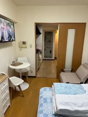 a room with a bed and a table and a couch at \u65b0\u5bbf\u5b89\u975c\u306e\u5bb6-A quiet home in Shinjuku - a 26 square meter double bed room that feels like home206 in Tokyo