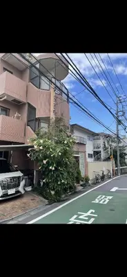 a car parked on a street next to a building at \u65b0\u5bbf\u5b89\u975c\u306e\u5bb6-A quiet home in Shinjuku - a 26 square meter double bed room that feels like home206 in Tokyo