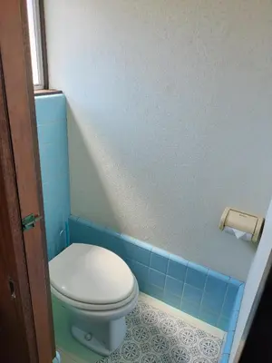a blue tiled bathroom with a toilet in it at JOY HOUSE Near Ikebukuro in Tokyo