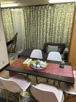 a dining room with a table and chairs with food on it at JOY HOUSE Near Ikebukuro in Tokyo