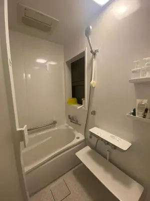 a white bathroom with a tub and a sink at Artful Cats house in Tokyo