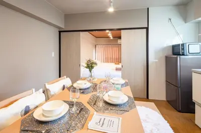 a dining room with a table and a refrigerator at Shinagawa-ku - Apartment - Vacation STAY 17329 in Tokyo