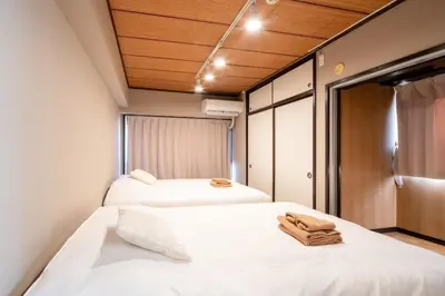 two beds in a small room with wooden ceilings at Shinagawa-ku - Apartment - Vacation STAY 17329 in Tokyo