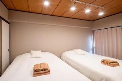 two beds in a room with two towels on them at Shinagawa-ku - Apartment - Vacation STAY 17329 in Tokyo