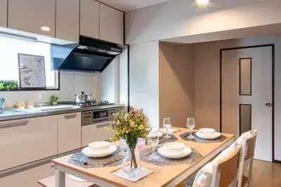 a kitchen and dining room with a wooden table and chairs at Shinagawa-ku - Apartment - Vacation STAY 17329 in Tokyo