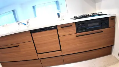 a kitchen with wooden cabinets and a stove at Daiichi House in Tokyo