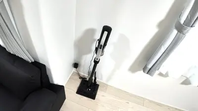 a black vacuum in the corner of a room at Daiichi House in Tokyo