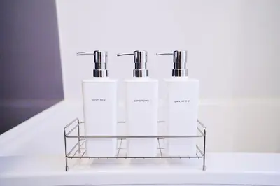 two white bottles sitting on a glass shelf at Bohemian Tokyo in Tokyo