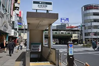 a sign for a theater on a city street at Village Gotanda in Tokyo