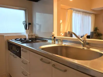 a kitchen with a large sink and a stove at Village Gotanda in Tokyo